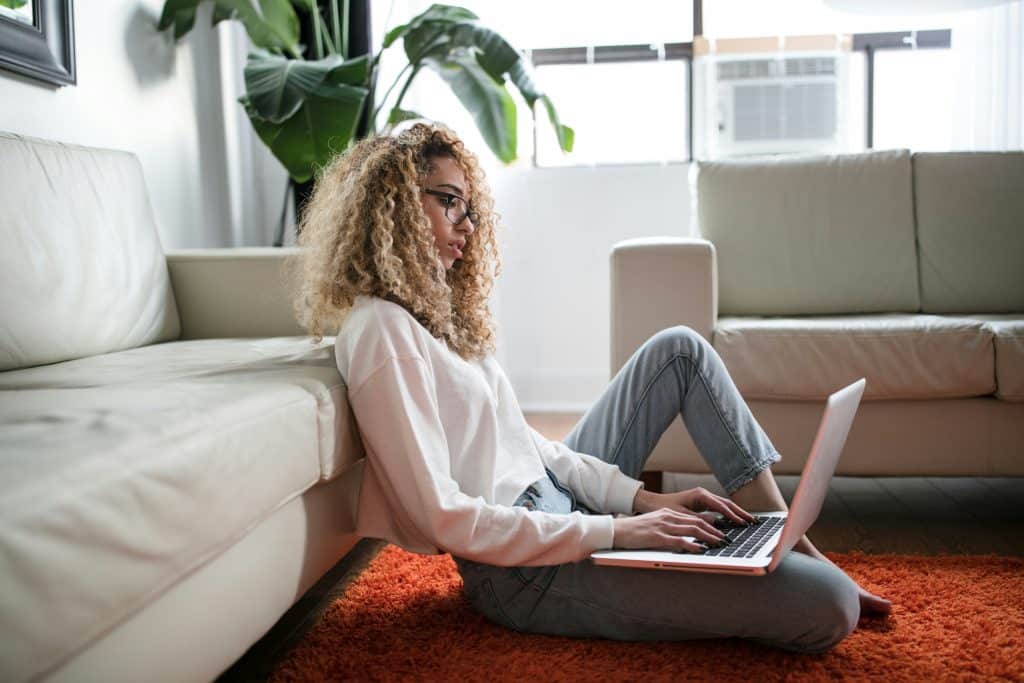 a woman sitting down with her laptop