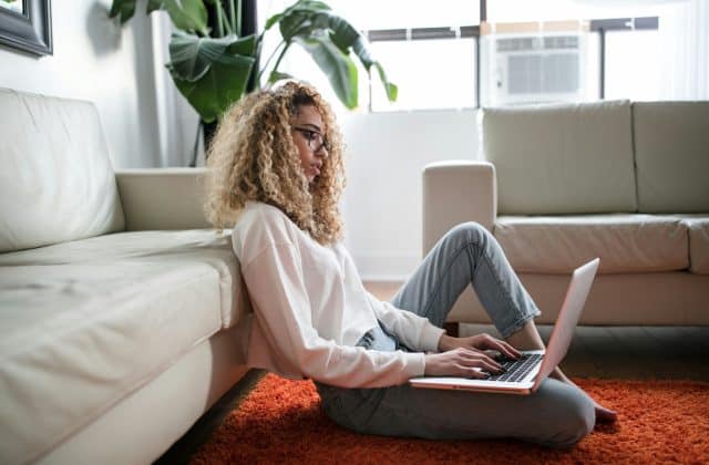 a woman sitting down with her laptop